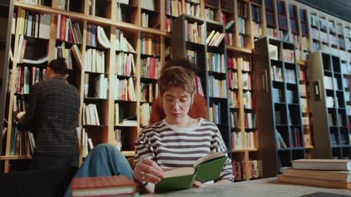 Time Lapse of Female Student Reading Book during Day in Library