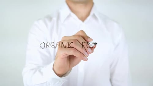 Man Writing Organic Food on Glass