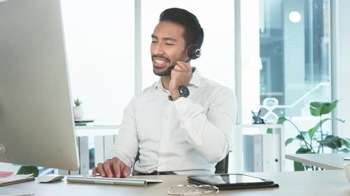 Friendly call center agent using a headset while consulting for customer service