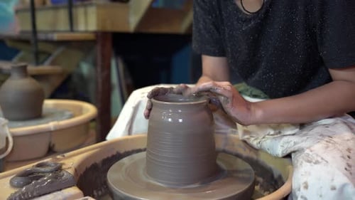 People Creating Pottery in Studio. Female artisan creating handmade ceramics in pottery workshop