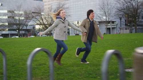 Young Couple Running in City Park,