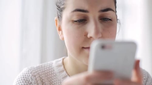 Woman Using Smartphone Indoors, Close Up