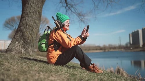 Elderly Lady Taking Selfie By Modern Smartphone in Park Active Life in Old Age Retiree Woman Sitting