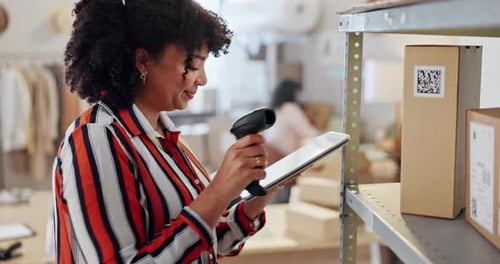 Woman Scanning Barcode on Box in Clothing Warehouse