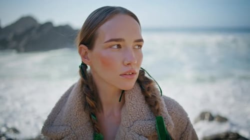 Seashore Girl Looking Camera at Foaming Ocean Portrait Contemplative Calm Model
