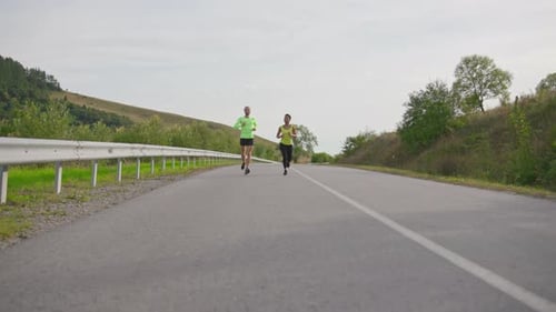 Healthy Adults Running on Rural Road for Fitness