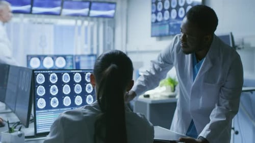 Medical Professionals Reviewing Brain Scans in Lab