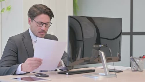 Adult Typing At A Workplace Computer