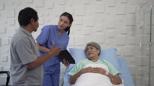 Doctor is take care senior patient at hospital room.