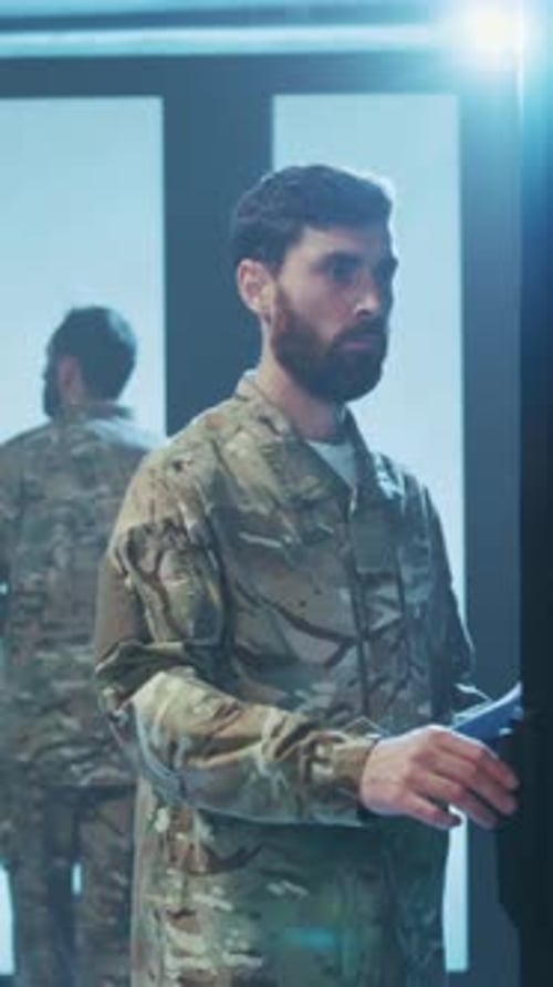 Man in Military Uniform Writes in Data Center