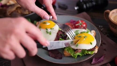 Cutting Delicious Egg and Bacon Sandwich on Toast