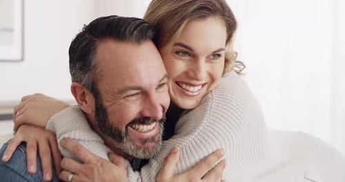 Happy Couple Embracing and Laughing Indoors