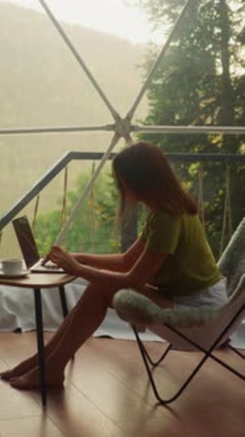 Woman Working on Laptop in Dome Home