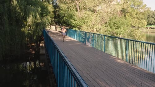 Fitness Woman Running Through Park