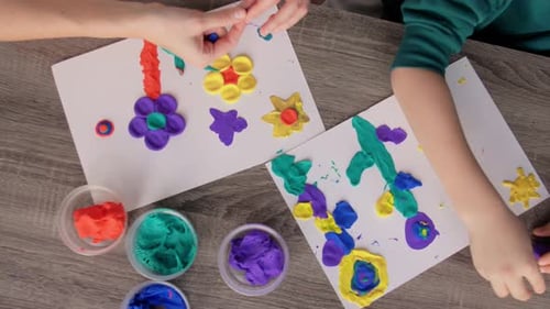Child and Adult Playing with Colorful Modeling Clay