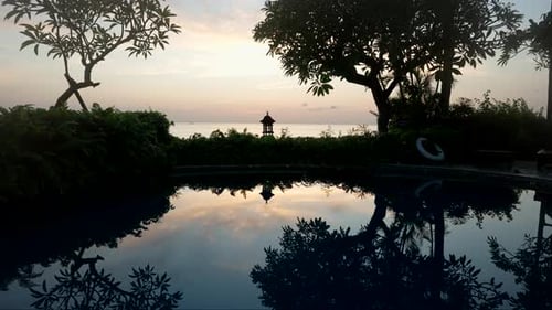 Silhouettes Reflected On The Swimming Pool On The Luxury Hotel Resort In Amed, Bali Indonesia. Stati