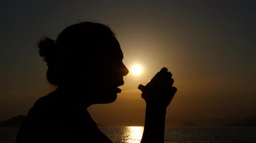 Female with Inhaler on Evening Beach