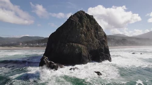 Large waves hit Haystack Rock in the autumn