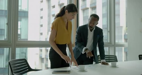 Business Professionals Reviewing Data in Bright Office