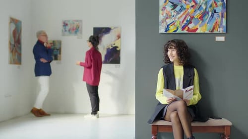 Female Visitor Reading Booklet in Art Gallery