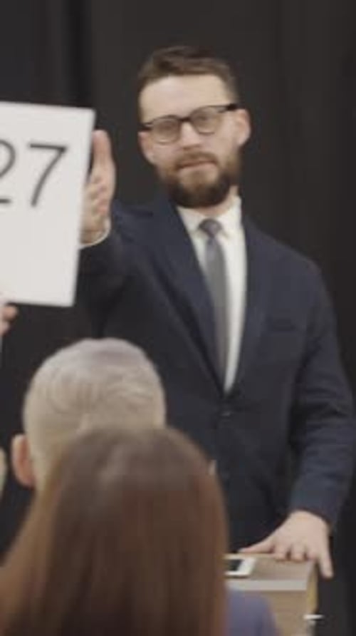 Man at Podium Leading an Auction