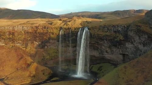 Aerial pullback from Seljalandsfoss waterfall revealing breathtaking Natural Scenery, Iceland