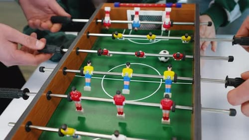 Students Playing Table Football Intense Game Action