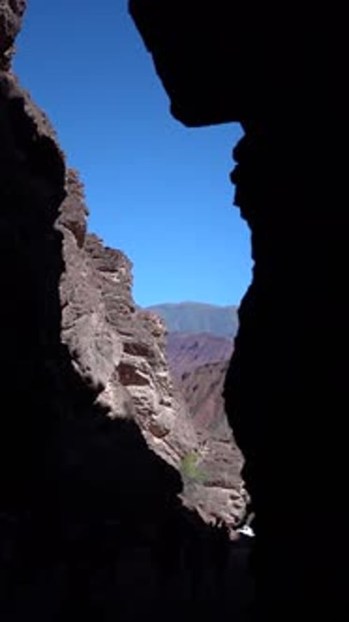A mountain range is visible in the distance with a clear blue sky