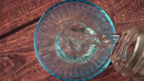 Clear Liquid Being Poured into a Glass
