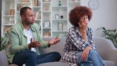 Couple Arguing on Couch in Living Room