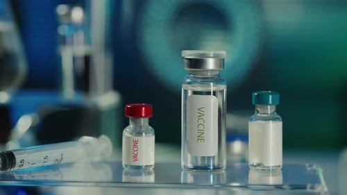 Vaccine Vials and Syringe in Bright Lab Setting