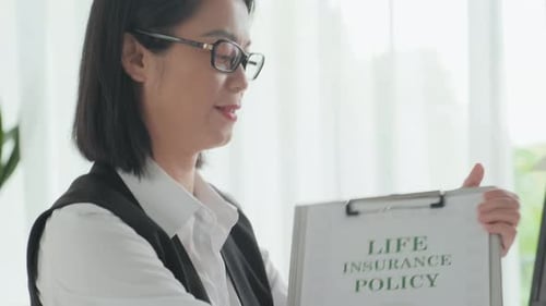 Female Agent Offering Life Insurance Policy to Clients