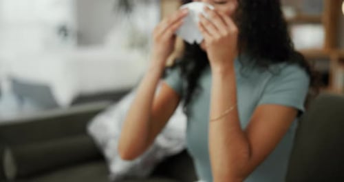 Young Adult with Tissue Blowing Nose