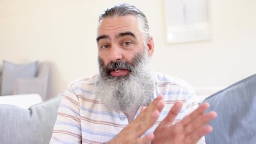 Man with Beard Talking to Camera Indoors