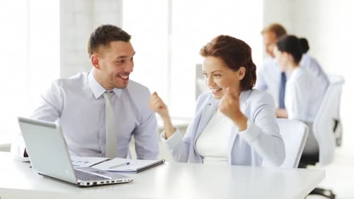 Business People In Office Making High Five Gesture