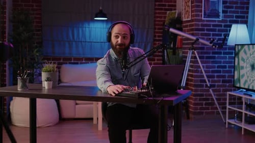 Man Vlogger Filming Video with Podcast Equipment in Studio Recording Online Vlog Using Digital