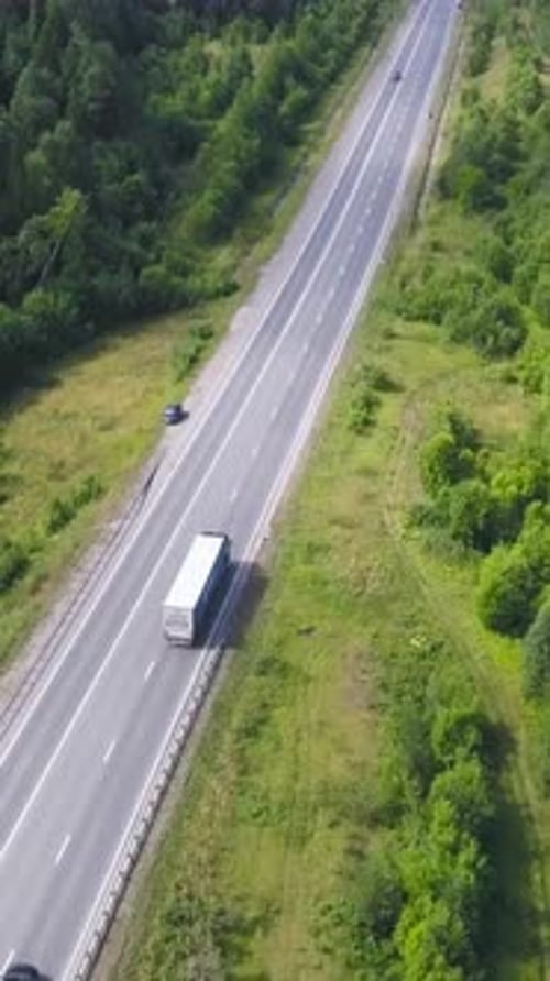 Top View of Countryside Highway in Forest Area Clip Rural Road with Traffic of Cars and Trucks Going