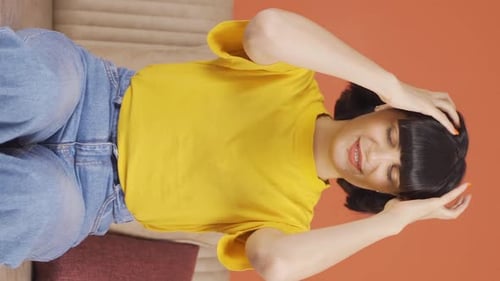 Vertical video of Young woman having a nervous breakdown in front of the camera.