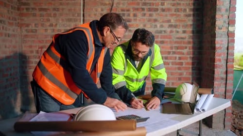 Engineer, team and drawing at construction site with blueprint, laptop and talk for building design