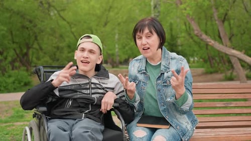 Friendly Wheelchair Interaction Engaging And Warm Exchange On Park Bench Cheerful Moment Of