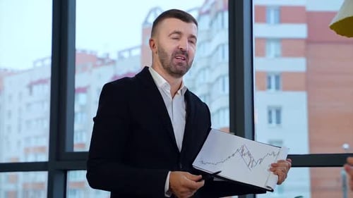 Professional Man Presenting Graph in Office