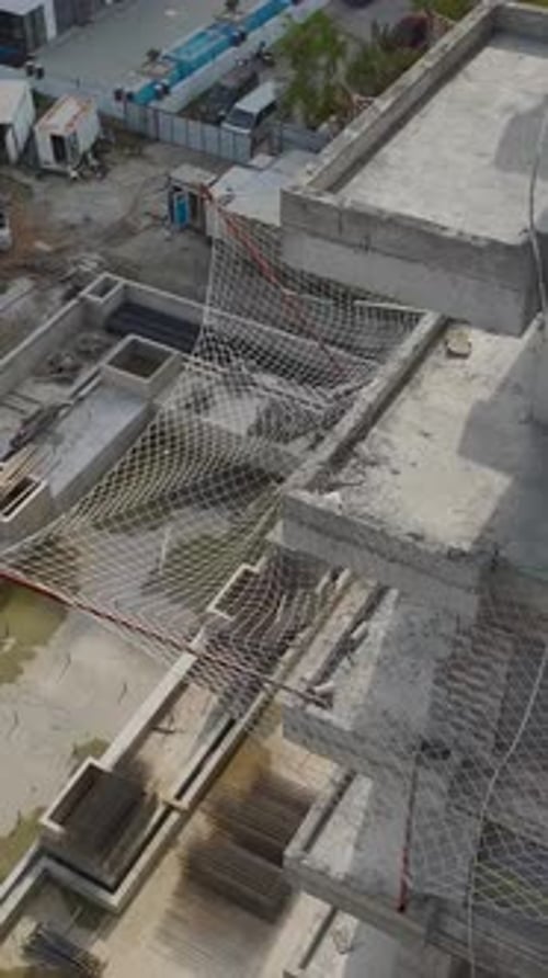 Vertical Aerial Shot Construction Site with Concrete Frames and Central Void Structure