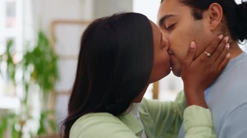 Loving Couple Embracing and Kissing Indoors