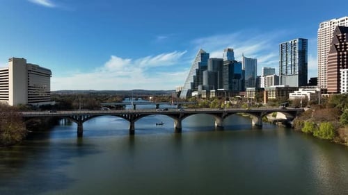Aerial view of traffic on bridge in downtown Austin, sunny, fall day in Texas, USA - descending, dro