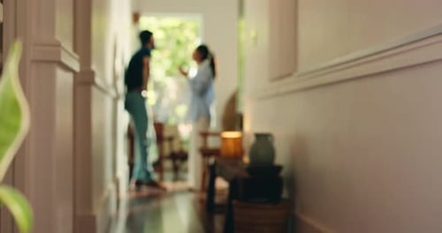 Blurred Man and Woman Arguing in Hallway at Home