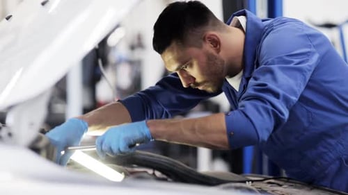 Car Mechanic Repairing Car Engine Wearing Blue Gloves