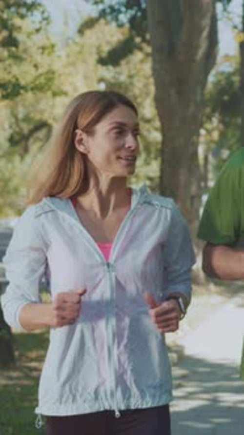 Healthy Outdoor Running Woman Exercises in Sunny Park Energetic Woman Runs Through Lush Park During