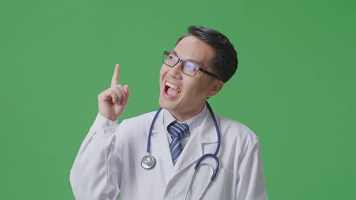 Asian Male Doctor With Stethoscope Thinking Then Raising His Index Finger On Green Screen Background