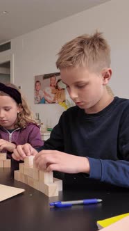 Children Building Wooden Block Tower Together at Home, Education Stock ...