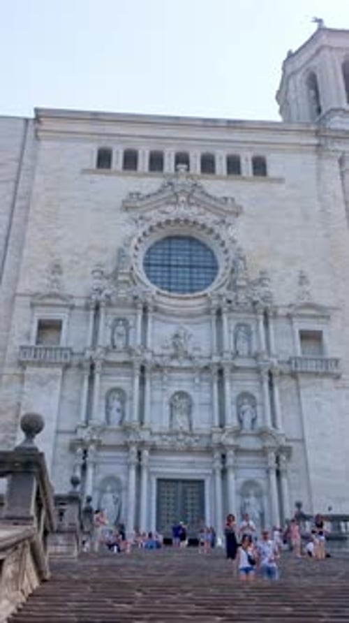 Tourists Visiting the Baroque Facade of Girona Cathedral in Spain